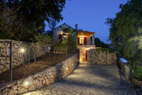 a stone path leading to a house with lights at Villa Zoe (formerly Villa Eboros) in Ratzaklíon