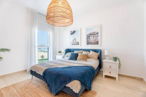 a bedroom with a bed with a blue blanket at Modern2BR ElegantYas Island703 in Abu Dhabi