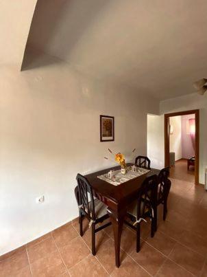 a dining room with a table and chairs at Σπίτι στα Έλατα in Palaiochórion