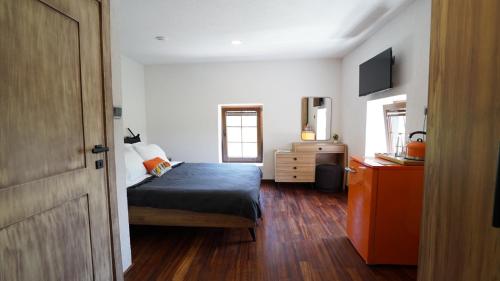 a bedroom with a bed and a dresser and a mirror at Muyo House in Urla