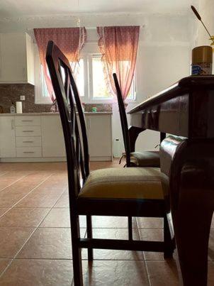 a dining room with a table and two chairs at Σπίτι στα Έλατα in Palaiochórion