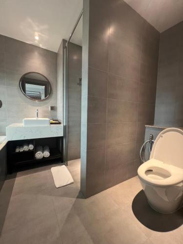 a bathroom with a toilet and a sink at Condotel The Arena Cam Ranh Light Tower in Dien Khanh