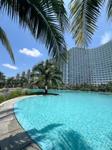 a large swimming pool in front of a large building at Condotel The Arena Cam Ranh Light Tower in Dien Khanh