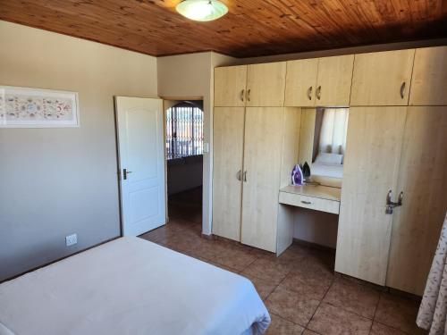 a bedroom with a bed and a sink and cabinets at Golden Dawn Chalets in La Mercy