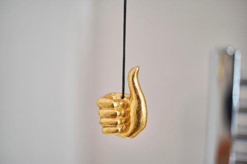 a gold hand hanging on a wall at Hideaway in Amble