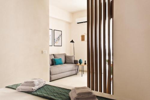 a living room with a couch and a mirror at Verdeacqua Home in Castellammare del Golfo