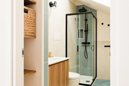 a bathroom with a shower with a toilet and a sink at Verdeacqua Home in Castellammare del Golfo