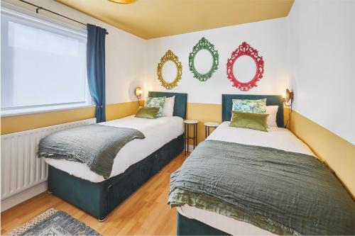 a bedroom with two beds and a window at Hideaway in Amble