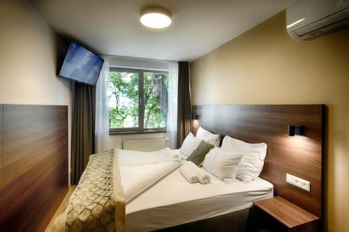 a bedroom with a large bed with a window at River View Apartments Hotel in Bratislava