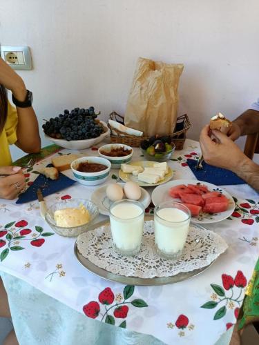 a table topped with plates of food and fruit at Guest house Fetie in Berat