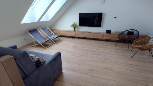 a living room with a couch and a flat screen tv at Bukowska House in Sulechów