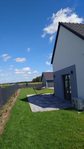 a small white building on a grass field at Bukowska House in Sulechów
