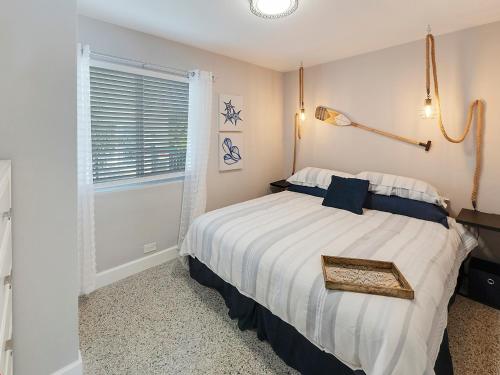 a bedroom with a large bed with a window at Seas the Day 1BR, Next to the Beach in West Palm Beach