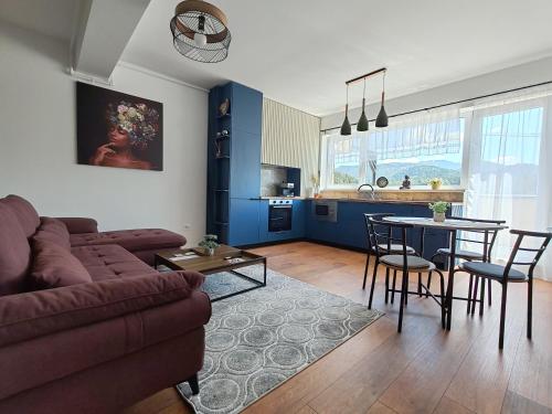 a living room with a couch and a table at Anto Apartments in Râşnov