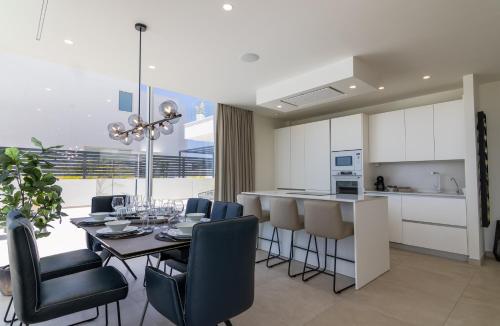 a kitchen and dining room with a table and chairs at Serenity Casa Encanto in Adeje