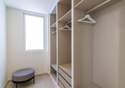 a walk in closet with a stool and a window at Serenity Casa Encanto in Adeje