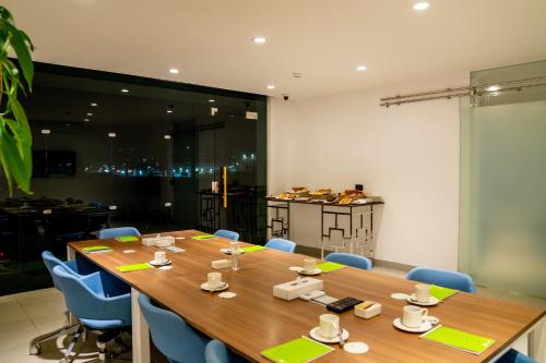 a conference room with a large wooden table and blue chairs at Palma Hotel in Port Said
