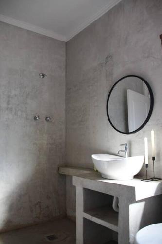 a bathroom with a sink and a mirror at Yours in Bloemfontein