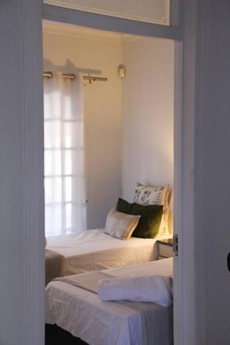 a room with two beds and a window at Yours in Bloemfontein