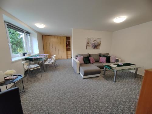 a living room with a couch and a table at Apartments Merci in Ostrava