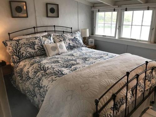 una camera da letto con un letto grande con cuscini di Compass Rose a Boothbay Harbor