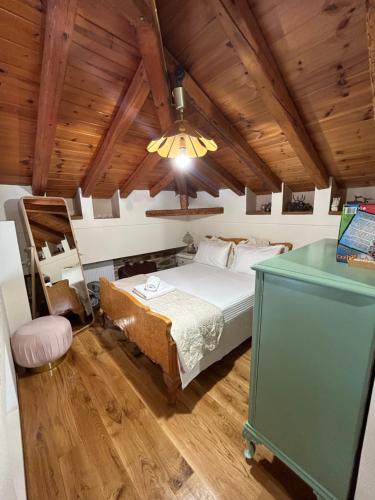 a bedroom with a bed in a room with a wooden ceiling at Αρχοντικό Γιούλη in Miléai