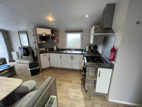 a kitchen with a sink and a stove top oven at 3 Bedroom Caravan MC37, Shanklin, Isle of Wight in Shanklin