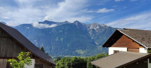 a view of mountains from between two buildings at Haus Tonelehof in Dellach im Drautal