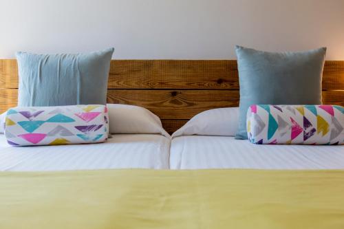 two pillows sitting on top of a bed at Hotel Tarongeta - Adults Only in Cadaqués