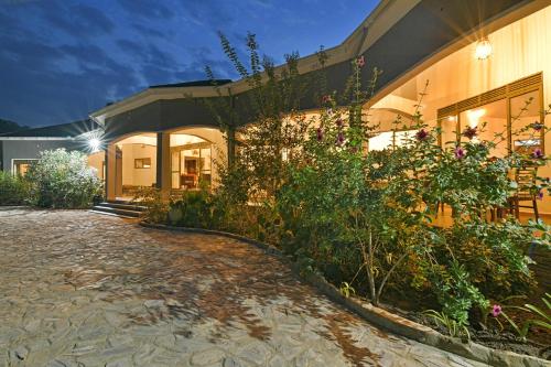 a building with a garden in front of it at Lake George View Golf Resort in Kahendero