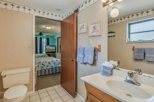 a bathroom with a sink and a toilet and a mirror at Coconut Breeze III - Monthly Beach Rental in Clearwater Beach