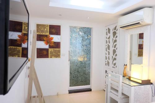 a room with a staircase and a glass door at Baanpoon Apartment in Chaweng
