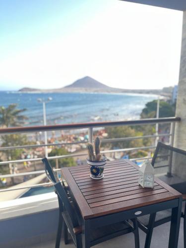 a wooden table on a balcony with a view of the ocean at Playa Grande, El Médano Best View in El Médano