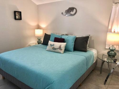 a bedroom with a bed with blue sheets and pillows at Goodland Waterfront Cottage in Goodland