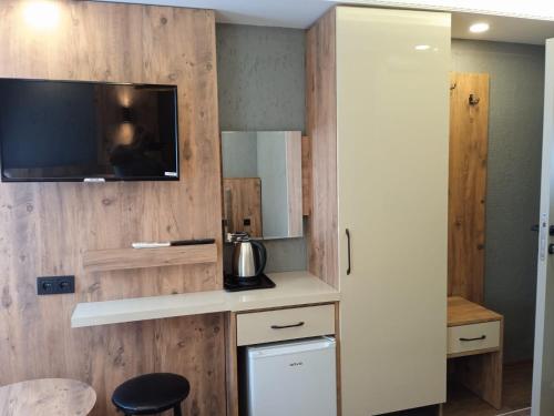 a kitchen with a tv on a wooden wall at Yellow Bull Istanbul hotel in Istanbul
