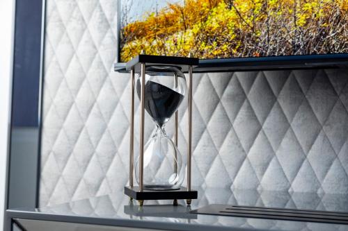 an hourglass sitting on top of a bed at Suite17 - Luxury GuestHouse in Giovinazzo