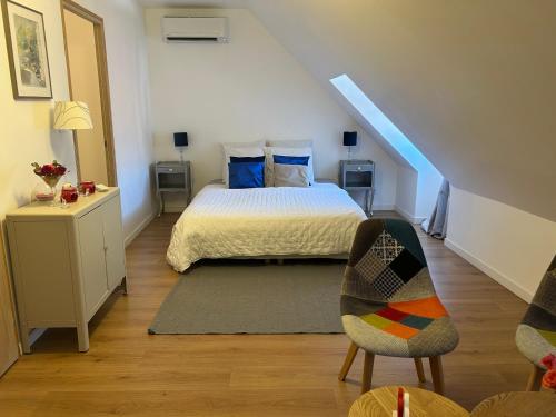 a bedroom with a bed and a stair case at Maison Céleste in Nuits-Saint-Georges