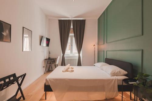 a bedroom with a bed with a teddy bear on it at Luxury Apartment - 8 person - Centro Storico Trieste in Trieste