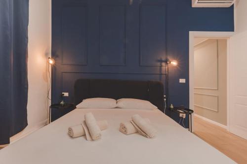 a large white bed with two pillows on it at Luxury Apartment - 8 person - Centro Storico Trieste in Trieste