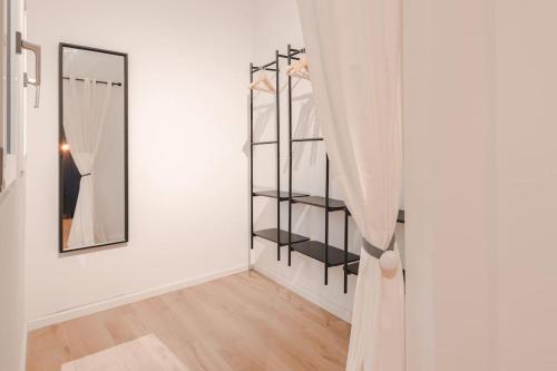 a white room with a mirror and a closet at Luxury Apartment - 8 person - Centro Storico Trieste in Trieste