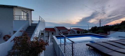 a swimming pool on the side of a building at Vila Blanka in Podgora
