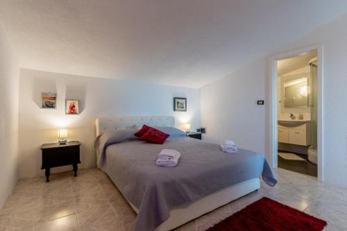 a bedroom with a bed with two towels on it at Vila Blanka in Podgora
