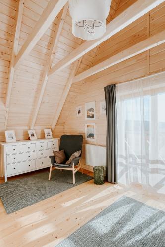 a room with a chair and a desk and a window at Villa Boguckowianeczka in Ząb