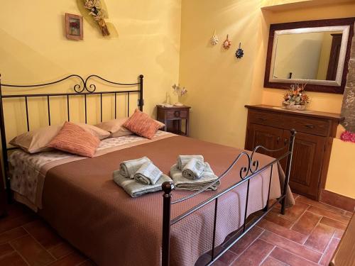 a bedroom with a bed with two towels on it at 18th Century Samnium Stone Residence in Alfedena