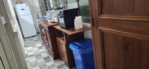 a kitchen with a counter with a microwave and a refrigerator at Meyenburg Units in Mount Morgan