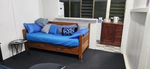 a couch with blue pillows on it in a room at Meyenburg Units in Mount Morgan