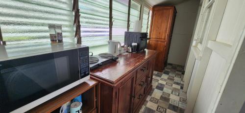 a kitchen with a counter with a microwave and a window at Meyenburg Units in Mount Morgan