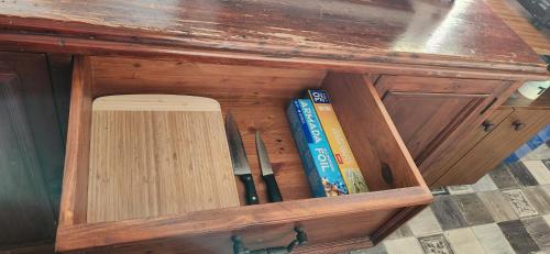 a wooden cabinet with some books in it at Meyenburg Units in Mount Morgan