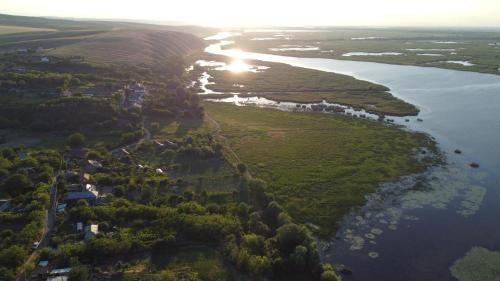 an aerial view of a river with the sunset in the background at Delta Sunrise in Somova