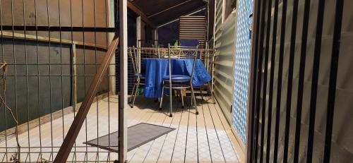 a room with a table and chairs in a cage at Meyenburg Units in Mount Morgan